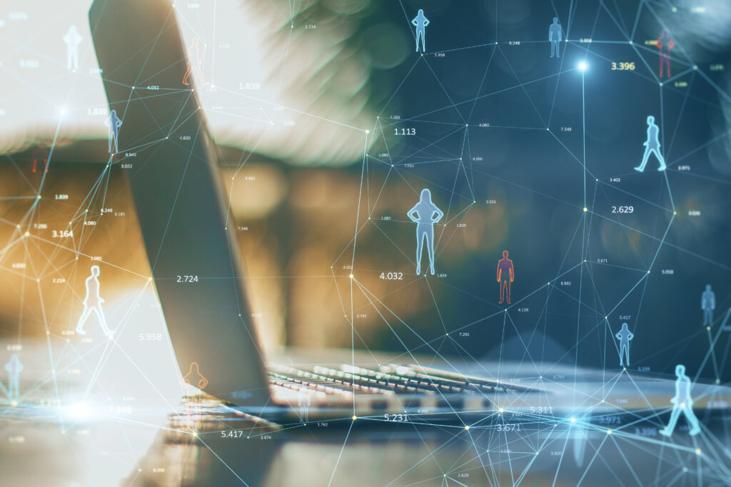 Close up of a laptop with silhouettes of people being connected with blue lines