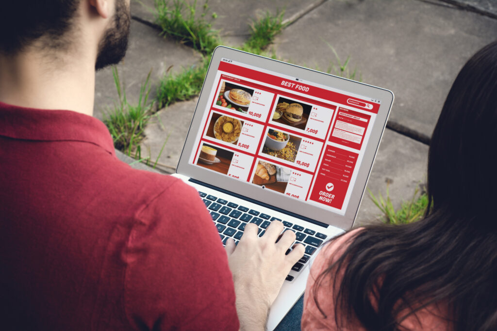7 Proven Ways to Find the Best Keywords for Local SEO 3 An over the shoulder view of two people looking at a food menu on a website.