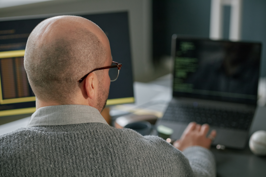 Middle aged man researching on his computer searching "does your company need SEO" for his business